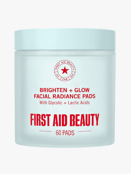 First Aid Beauty Brighten and Glow Radiance Pads in branded tub component on a light gray background